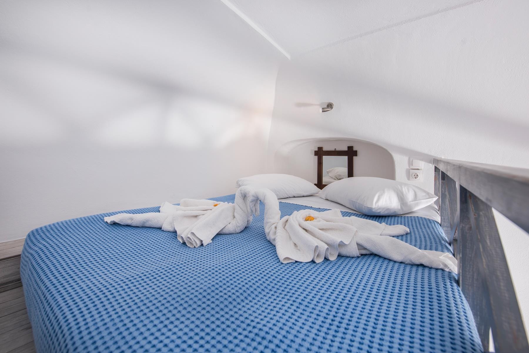 a bed with a blue comforter