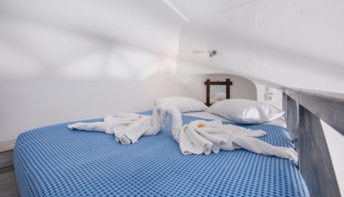 a bed with a blue comforter