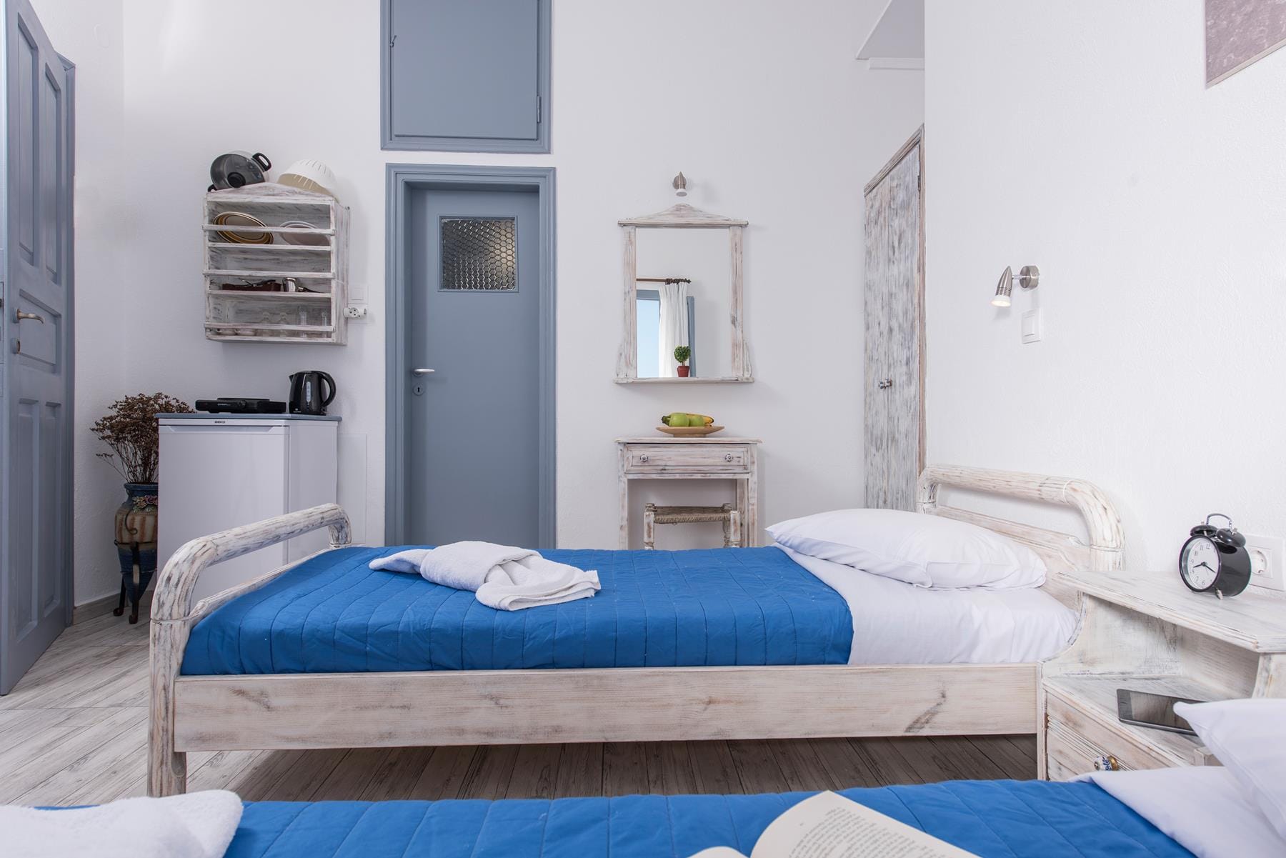 a room with a bed and a mirror