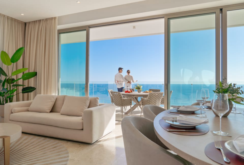 a couple of people in a room with a large window