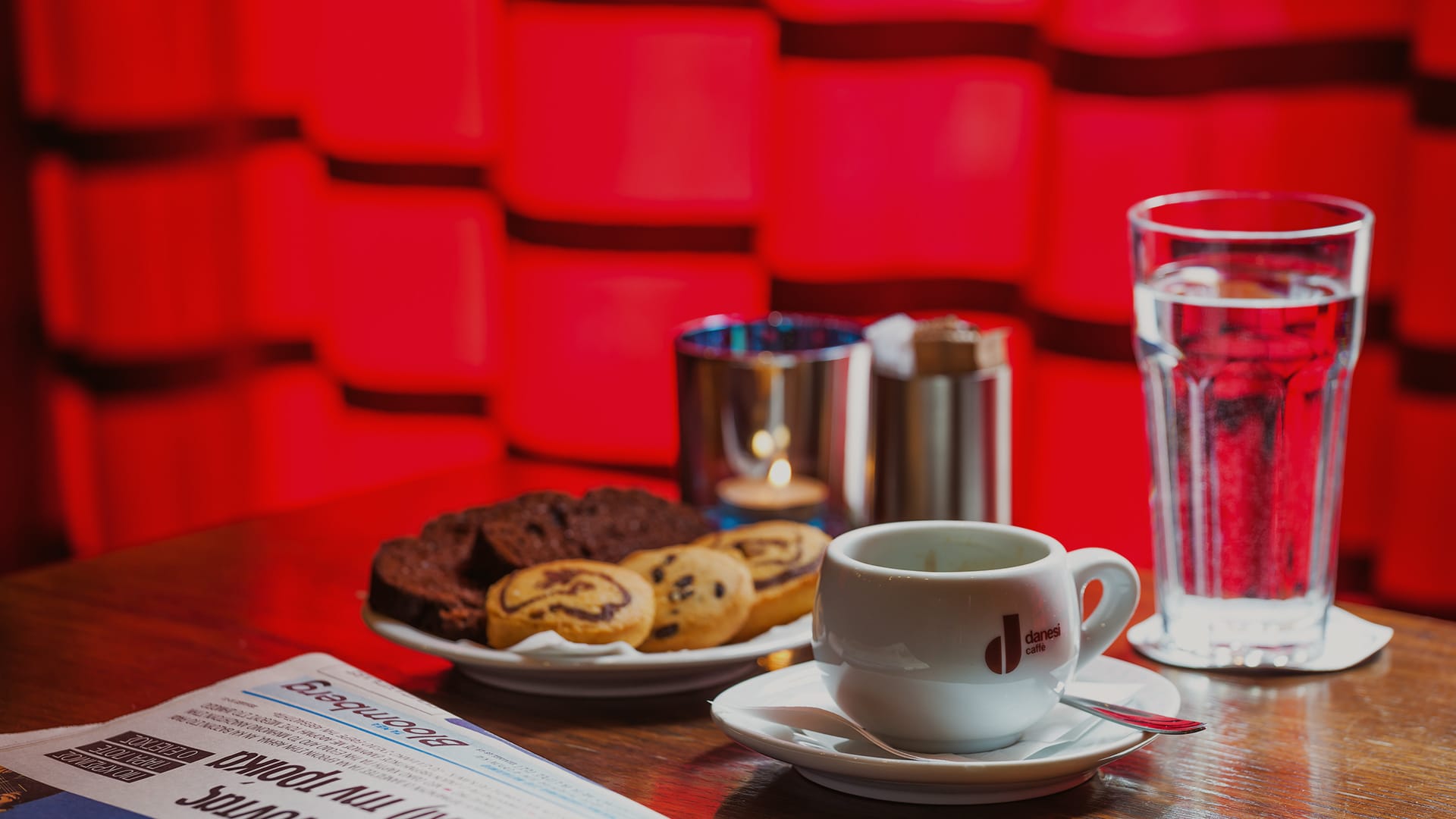 a plate of cookies and a glass of water on a table