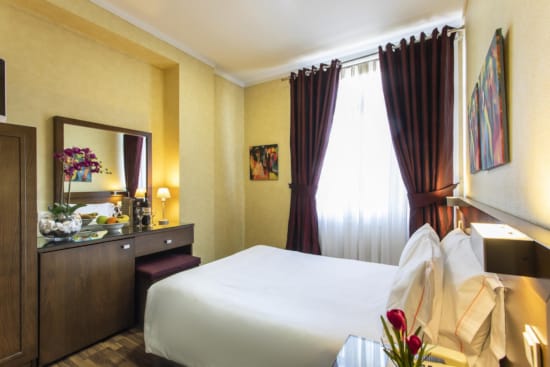 a bedroom with a bed and a mirror