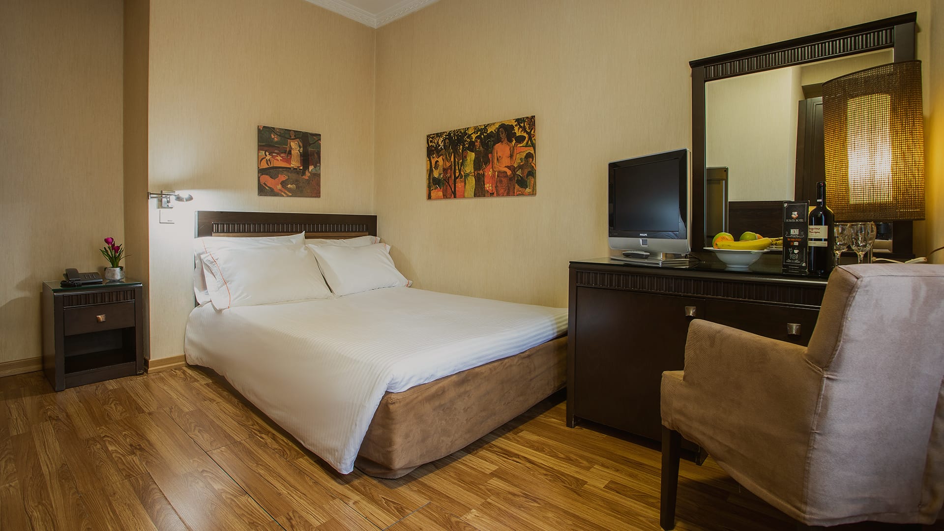 a hotel room with a bed and desk