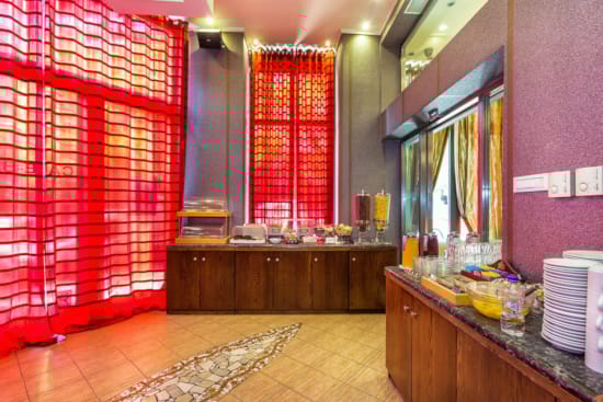 a kitchen with a red curtain