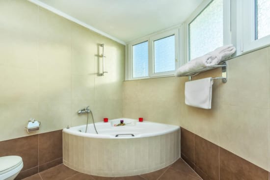 a bathroom with a tub and towels