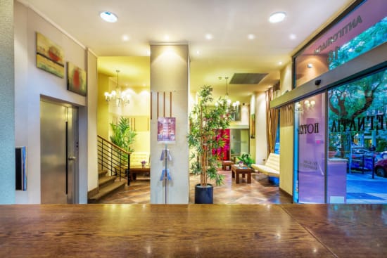 a large room with a large glass door and a plant in it
