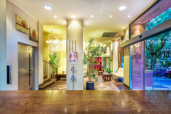 a large room with a large glass door and a plant in it