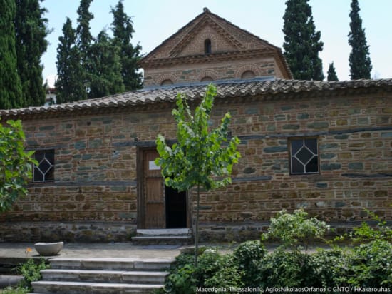 a brick building with trees in the front