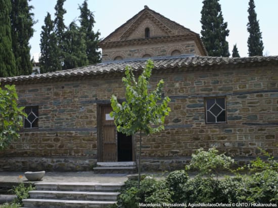 a brick building with trees in the front