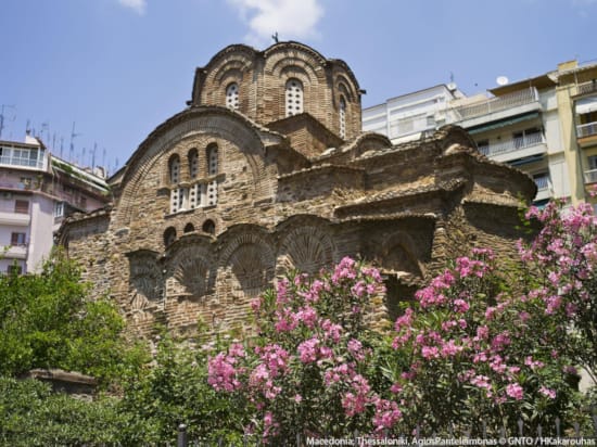 a stone bridge with pink flowers