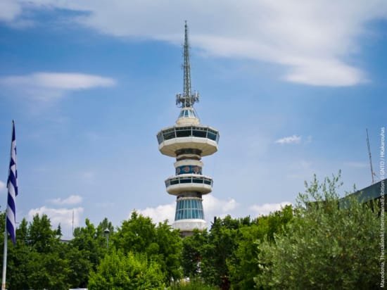 a tall tower with trees in the front