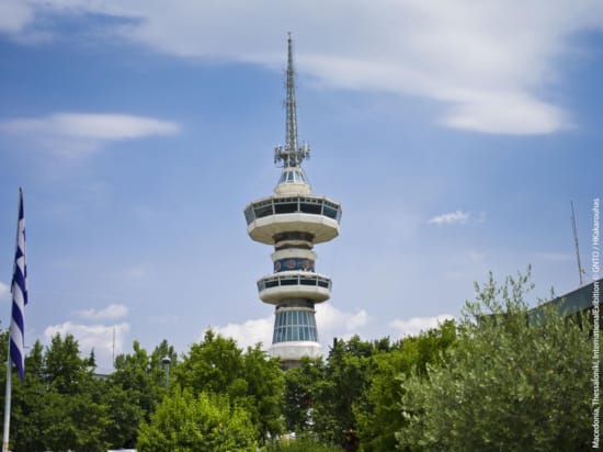 a tall tower with trees in the front