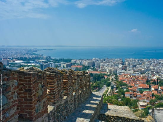 a city with a large body of water in the background