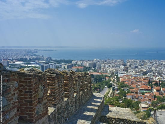 a city with a large body of water in the background