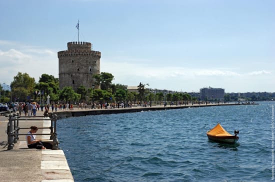 a boat in the water with Fort Denison in the background