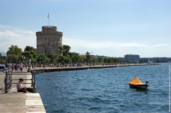 a boat in the water with Fort Denison in the background