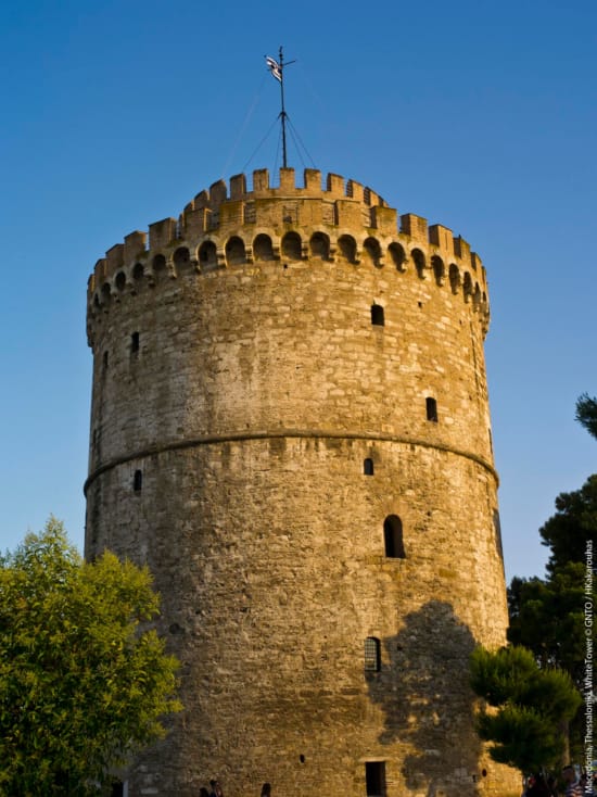 a stone tower with a cross on top