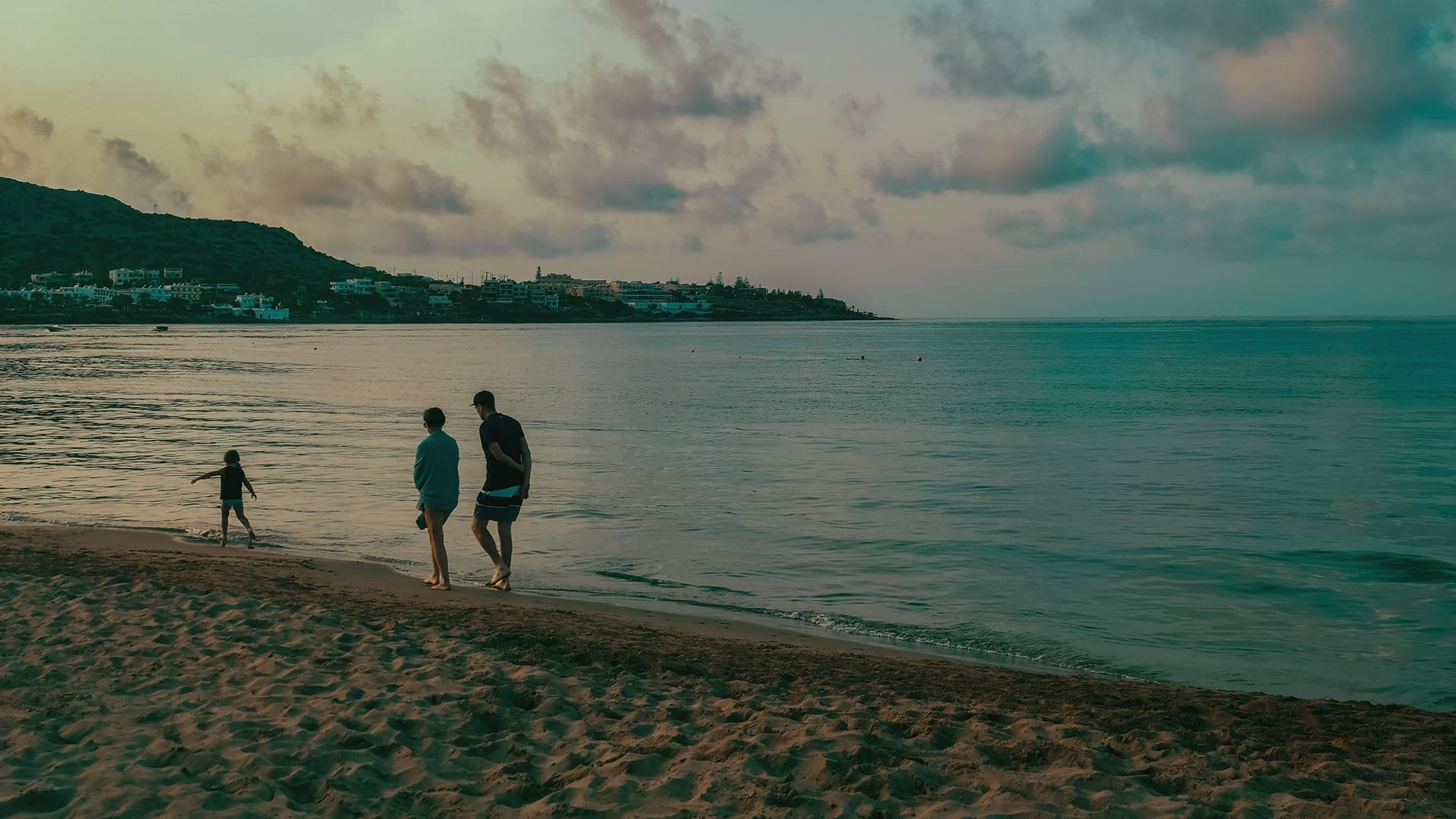 a group of people walking on a beach
