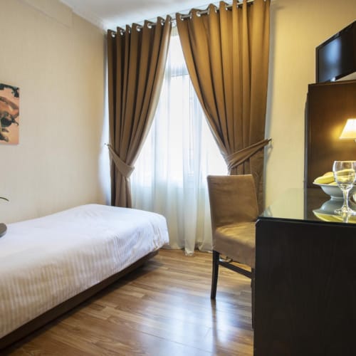 a hotel room with a bed and a desk