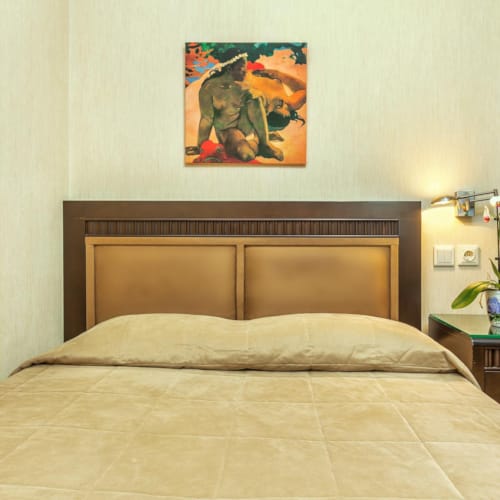 a bed with a lamp on the side