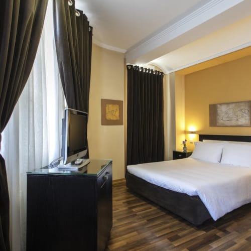 a bedroom with a bed and a tv