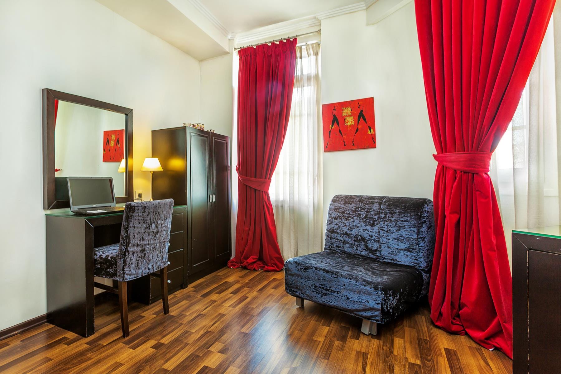 a room with a desk and chairs