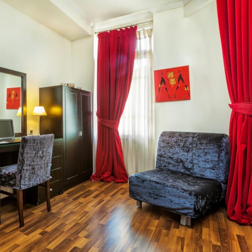 a room with a desk and chairs