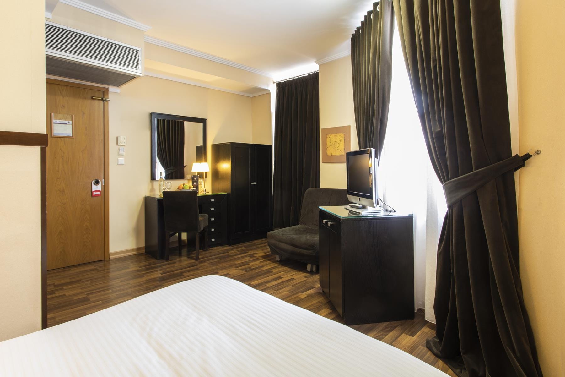 a room with a tv and chairs