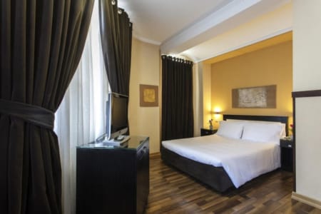 a bedroom with a bed and a tv