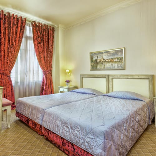 a bedroom with a bed and a pink curtain