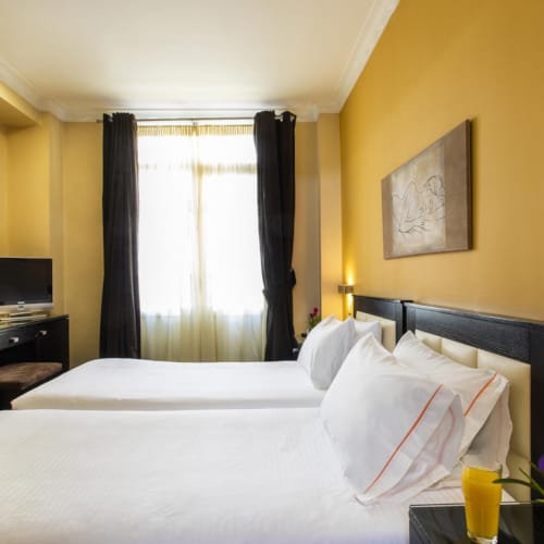 a hotel room with a bed and a tv