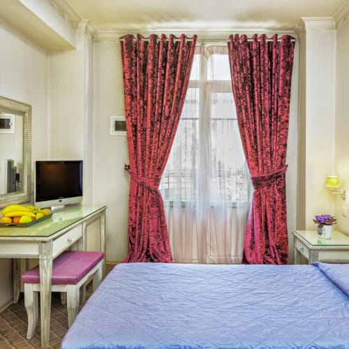 a bedroom with a bed and a desk