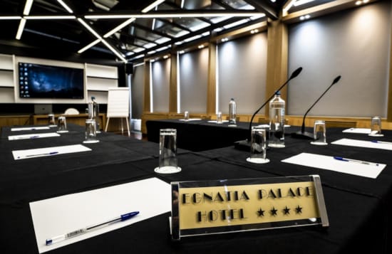 a table with a microphone and glasses on it