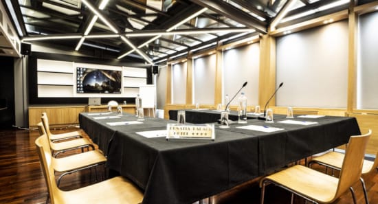 a kitchen with a bar and chairs
