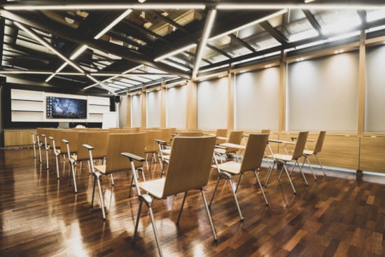 a room with chairs and a screen