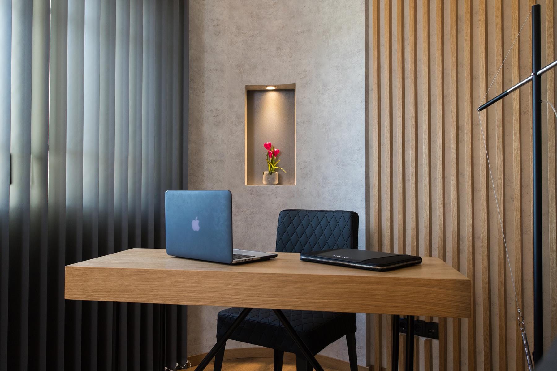 a desk with a laptop and a mirror