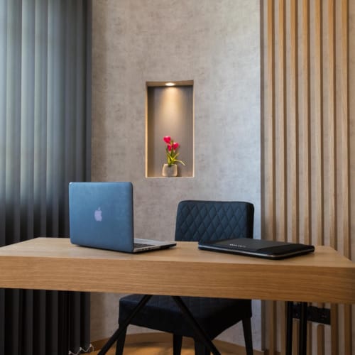 a desk with a laptop and a mirror