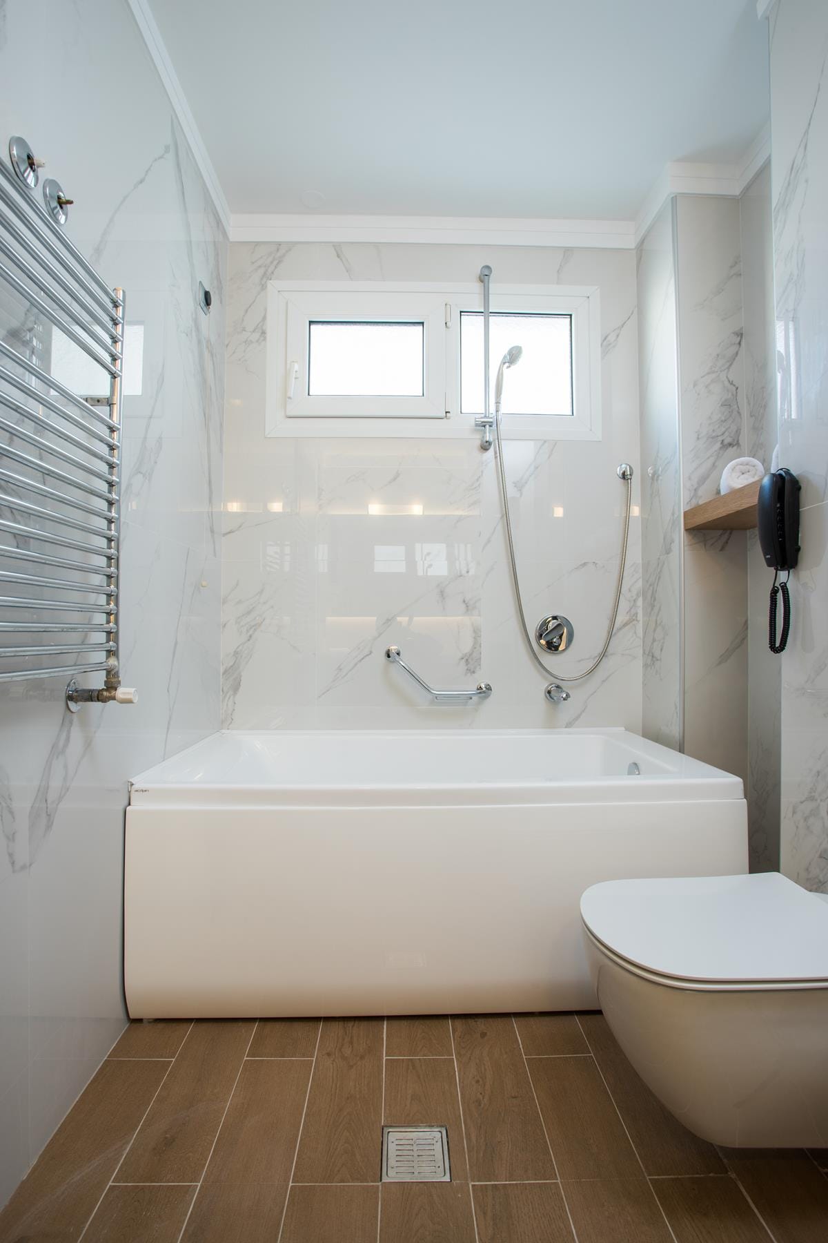 a bathroom with a tub and toilet