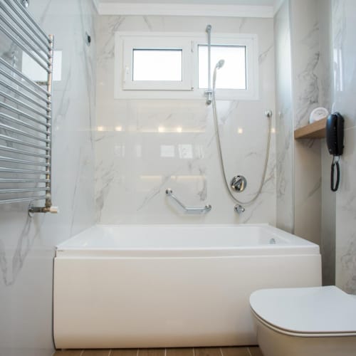 a bathroom with a tub and toilet