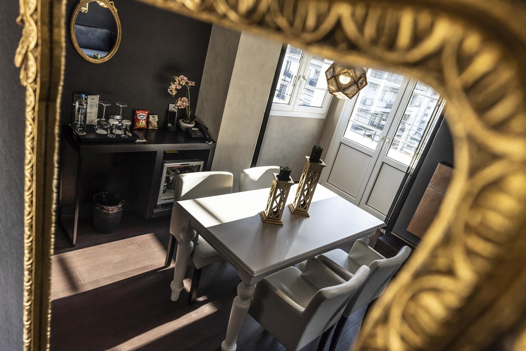 a table with a mirror and a chair in a room