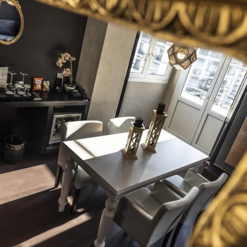 a table with a mirror and a chair in a room