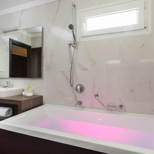 a bathroom with a tub and sink