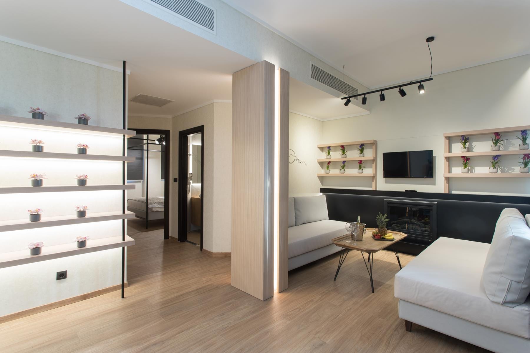 a living room with white furniture