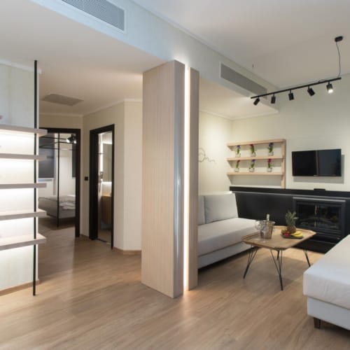 a living room with white furniture