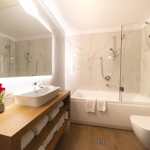 a bathroom with a tub sink and toilet