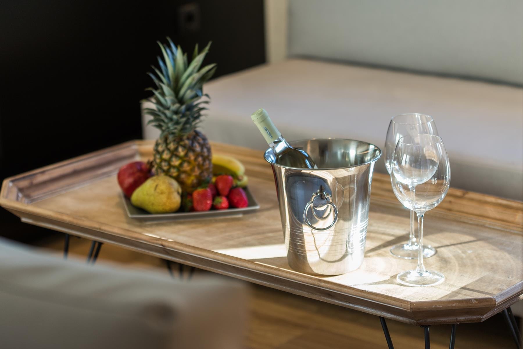 a table with a glass and a plate of fruit