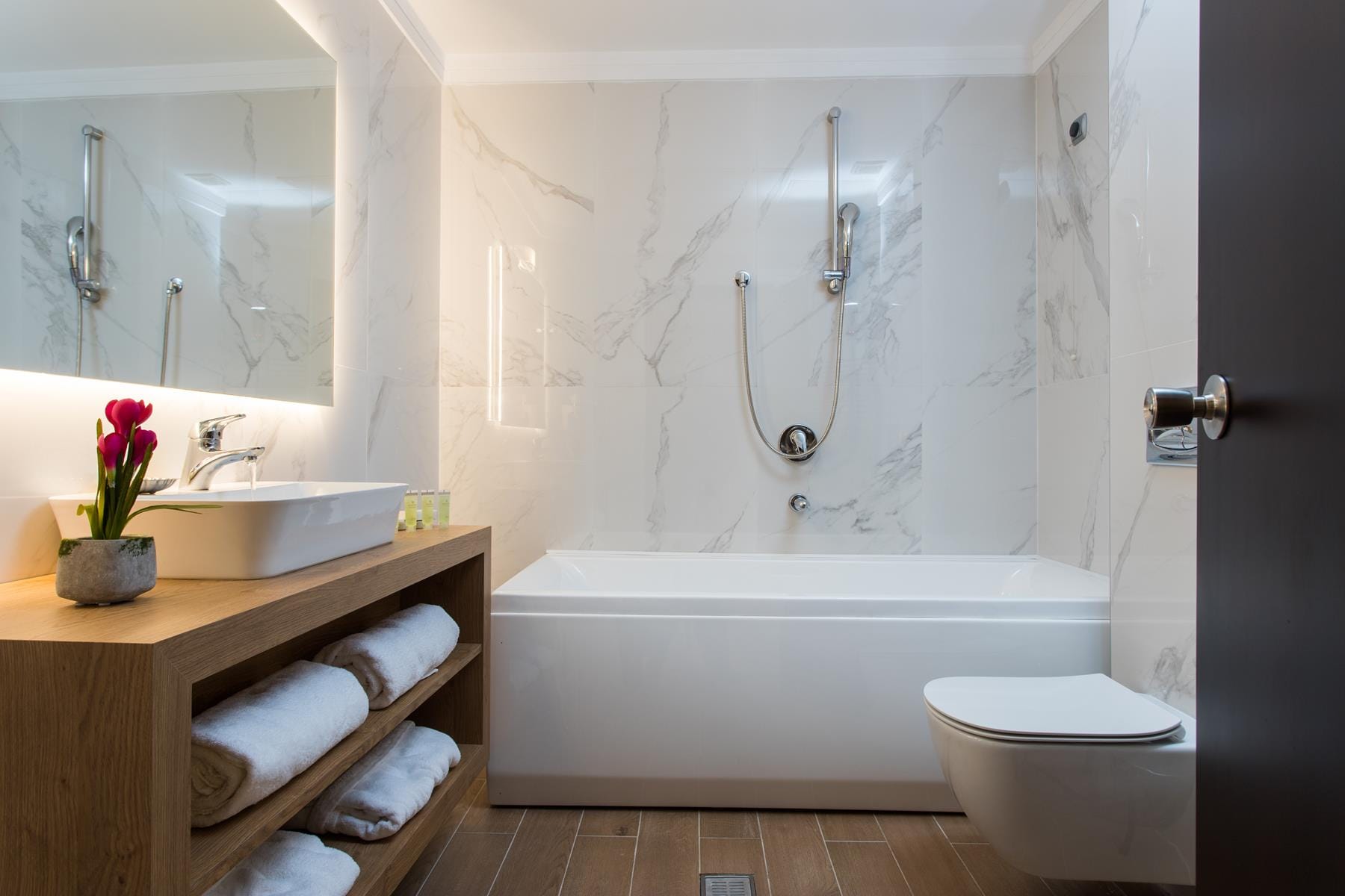 a bathroom with a tub sink and toilet