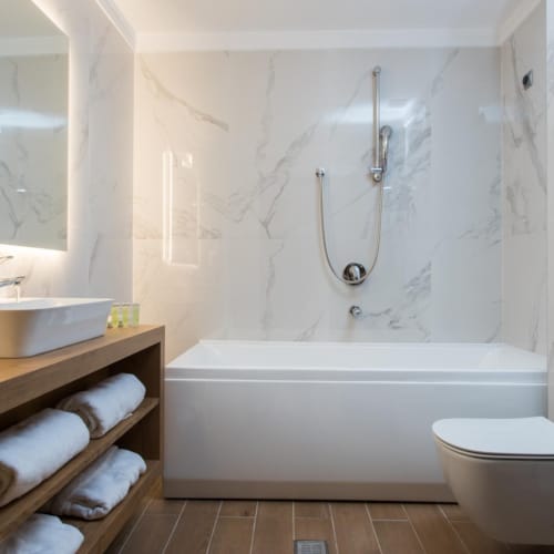 a bathroom with a tub sink and toilet