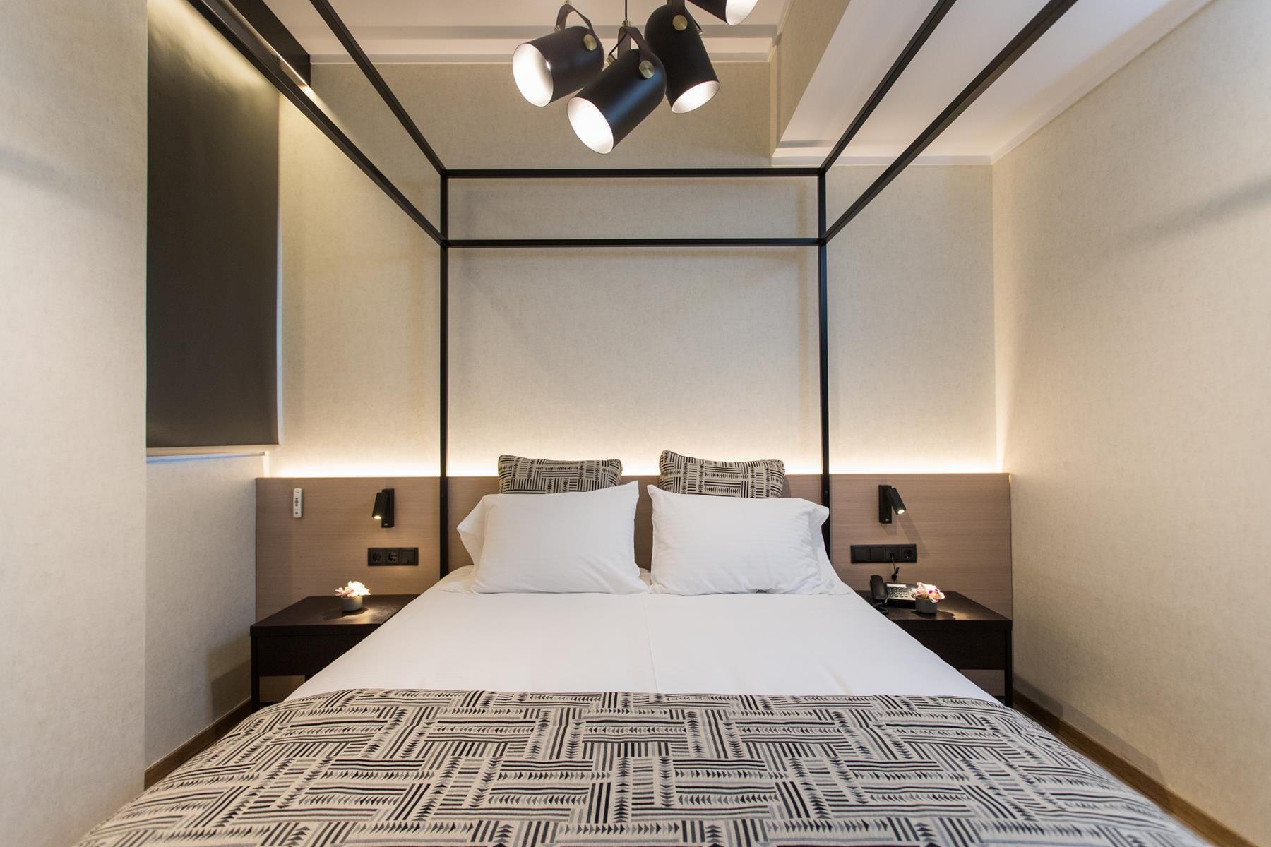 a bed with a large mirror above it