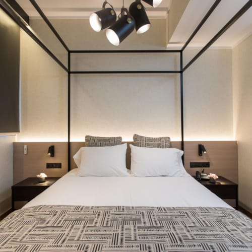 a bed with a large mirror above it